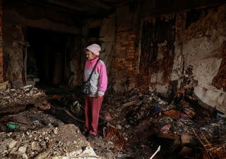 A resident stands in her room in a dormitory hit by a Russian drone strike, amid Russia's attack on Ukraine, in Odesa